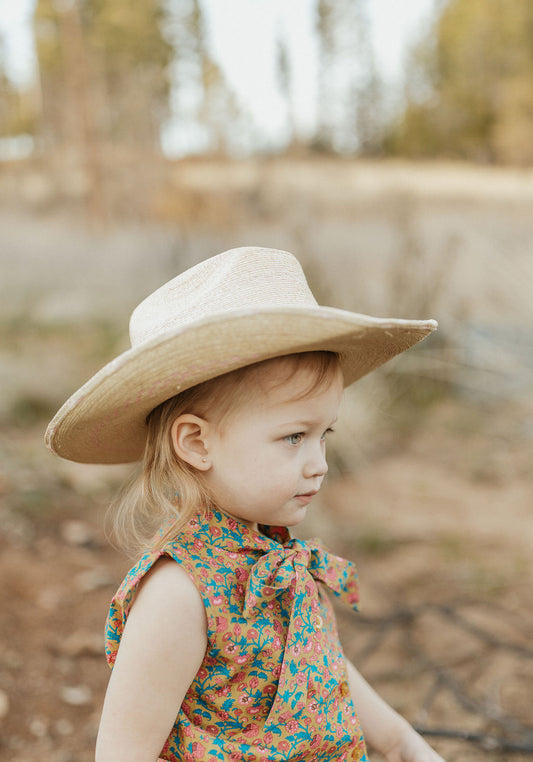 little cowgirl wearing palmleaf hat and unchained eight sleeveless lacey shirt country and western shirt for baby and kids both boys and girls areana kids crule girl shirt
