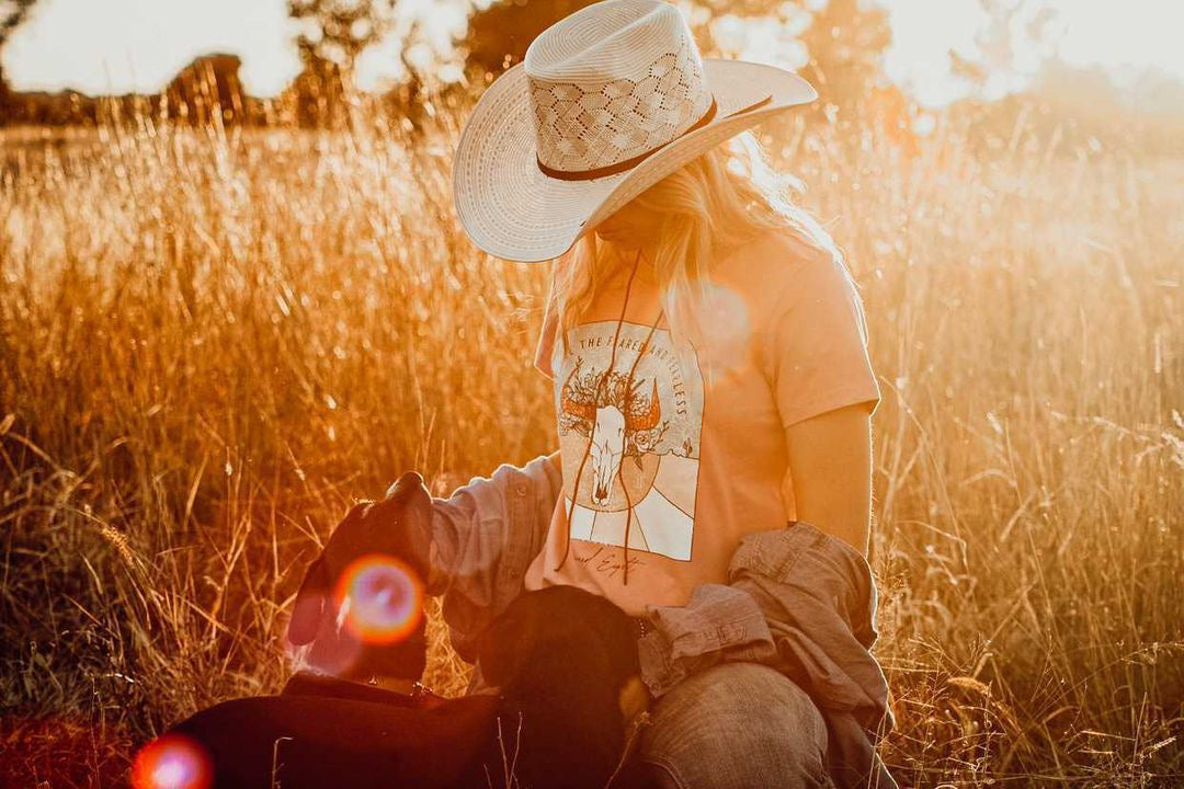 barrel racer in australia wearing feared and fearless unchained eight tee tshirt shirt with mavericks western straw hat next to stock horse. Australian cowgirl is wearing barrel racing buckle dashhound