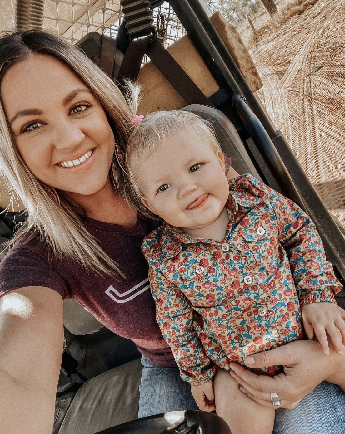 country kid bush kid wearing unchianed eight romper western onesier with mum on rural station mum is wearing kimes ranch tshirt