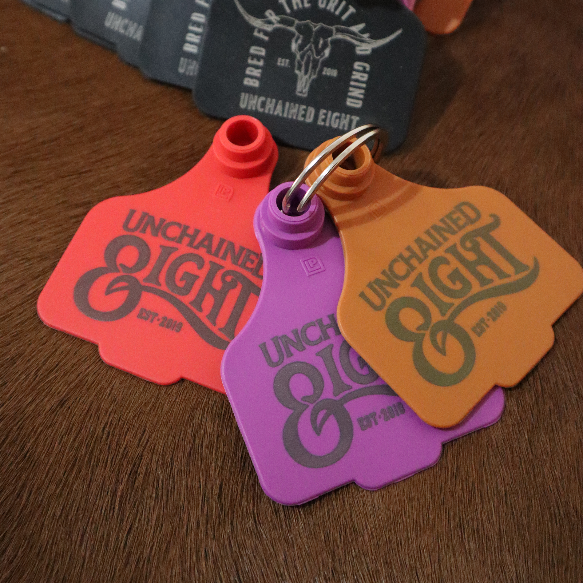 Classic country and western wear logo cattle tag keyring brown red black and purple